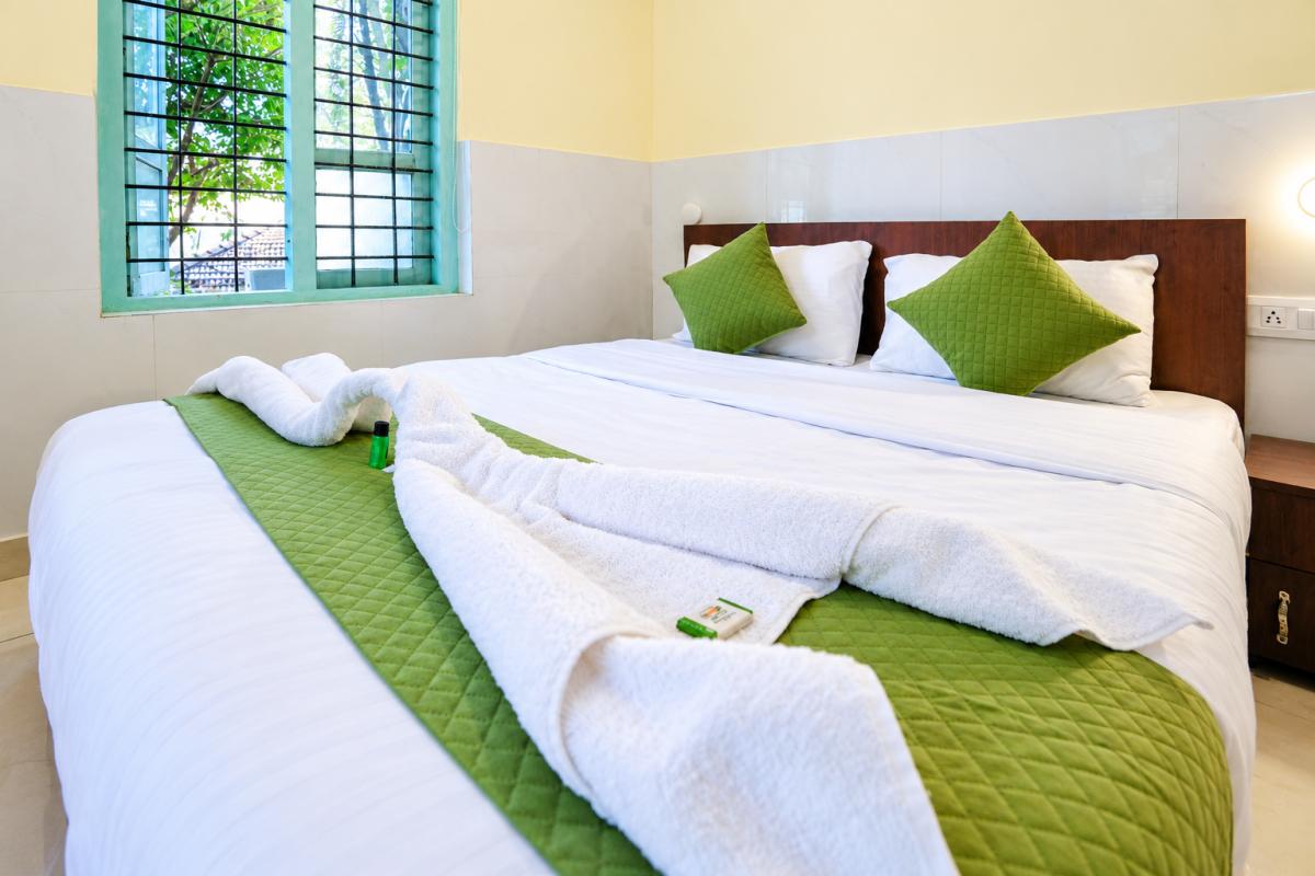 Bright Hotel Bedroom with Towel Arrangement